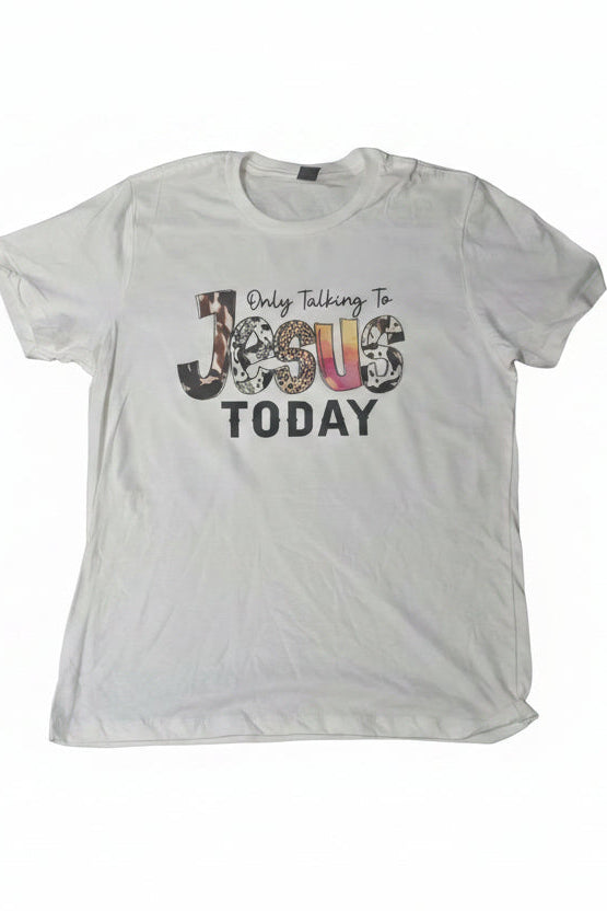 A white short-sleeve t-shirt laid flat on a dark gray textured carpet, featuring a graphic print that reads 'Only Talking To Jesus TODAY' with 'Jesus' filled with a floral pattern.