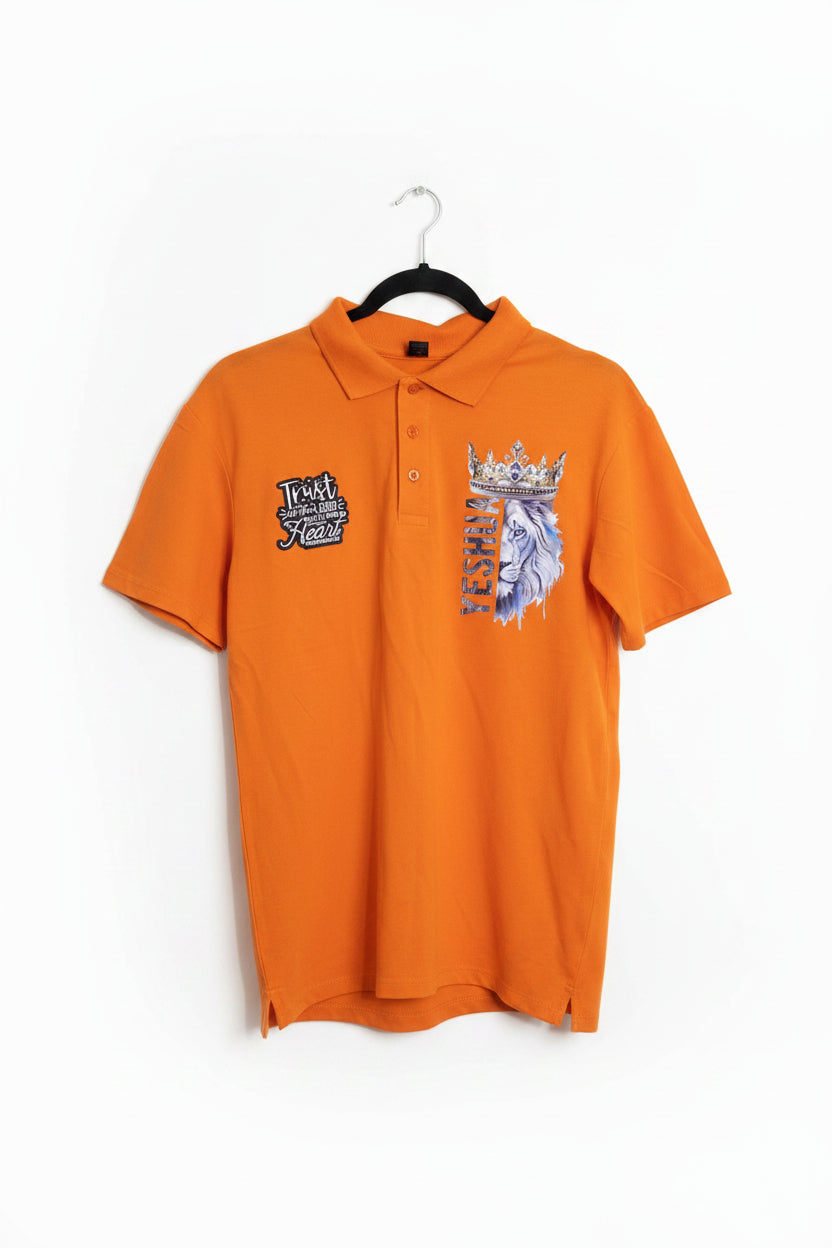 An orange short-sleeve polo shirt hanging on a black hanger, featuring a graphic print of a lion and crown on the left chest and a logo on the right sleeve.